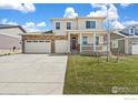 Attractive two-story home with a brick-accented facade, covered porch, and well-kept lawn at 1850 Sawtooth Mountain Dr, Berthoud, CO 80513