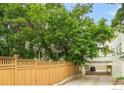 Charming home with lush green trees offering shade and privacy, a drive-through garage and fenced yard at 2444 9Th St # 4, Boulder, CO 80304