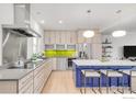 Updated kitchen with stainless appliances, island seating, and modern cabinetry at 2444 9Th St # 4, Boulder, CO 80304