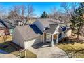 Well-maintained single-Gathering home showcasing a stone-accented entrance and an attached garage at 310 Diamond Cir, Louisville, CO 80027