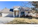 Charming home with stone accents, a well-maintained lawn, and inviting front porch at 310 Diamond Cir, Louisville, CO 80027