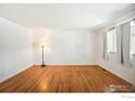 Bright living room featuring hardwood floors and ample natural light from a large window at 3120 Jefferson St, Boulder, CO 80304