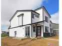 Stylish modern home with black trim, white siding, and a bright red door at 343 Pyramid Peak St, Berthoud, CO 80513