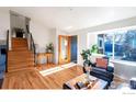 Cozy living room with hardwood floors, stairs, large window, and comfortable seating area at 359 S Jefferson Ave, Louisville, CO 80027