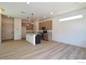 Modern kitchen featuring granite countertops, stainless steel appliances, and stylish pendant lighting over a center island at 377 Fickel Farm Trl, Berthoud, CO 80513