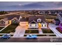 Charming home featuring a well-manicured lawn, cozy front porch, and a classic blue truck parked in the driveway at 405 Buckskin Rd, Berthoud, CO 80513