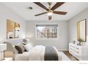 Well-lit bedroom with neutral colors, a ceiling fan, and ample natural light from the window at 4882 E Kentucky Ave # C, Denver, CO 80246