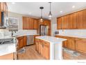 Bright kitchen features stainless steel appliances, light countertops, and a center island with seating at 4910 Crimson Star Dr, Broomfield, CO 80023