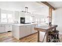 Modern kitchen features a large center island with seating, stainless steel appliances, and hardwood flooring at 4932 Valkyrie Dr, Boulder, CO 80301