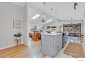 Modern, open kitchen with an island, skylights, hardwood floors, and stainless steel appliances at 4965 Ricara Dr, Boulder, CO 80303