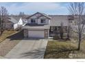 Charming two-story home with stone accents, attached two-car garage, and covered front porch at 5288 Buttesfield St, Firestone, CO 80504