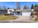 Charming two-story home with a well maintained front yard and driveway leading to a two-car garage at 6115 W 84Th Way, Arvada, CO 80003