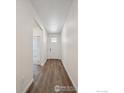 Clean hallway showcasing hardwood floors and a bright, welcoming atmosphere at 6501 14Th St, Frederick, CO 80530