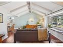 Bright living room with vaulted ceilings, hardwood floors, and a large window seat at 7288 Petursdale Ct, Boulder, CO 80301