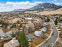 Stunning aerial view of the property with a mountain backdrop and close proximity to Bear Creek Elementary at 741 Ithaca Dr, Boulder, CO 80305