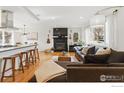 Bright and airy living room featuring hardwood floors, a fireplace, and comfortable seating arrangements at 741 Ithaca Dr, Boulder, CO 80305