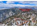 Illustrative aerial view of a beautiful wood home with trees and snow covered land at 84 Canon View Rd, Boulder, CO 80302
