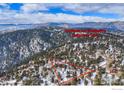 A mountain home is surrounded by trees, outlined in red, showcasing the expansive property at 84 Canon View Rd, Boulder, CO 80302