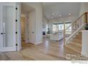 Inviting living room featuring vaulted ceilings, fireplace, and large windows for ample natural light at 960 Saint Andrews Ln, Louisville, CO 80027