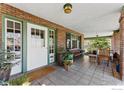 Inviting front porch with brick columns, tiled floor, and ample seating at 981 11Th St, Boulder, CO 80302