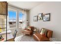 Comfortable office with neutral colors, modern decor, and natural light from large windows at 11 Chipeta Way, Lochbuie, CO 80603
