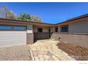 Charming single story home featuring brick accents, stone path, and attached garage at 1147 Crestmoor Dr, Boulder, CO 80303