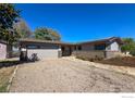 Single story home with an attached garage, stone path, and rock landscaping at 1147 Crestmoor Dr, Boulder, CO 80303