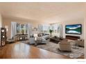 Spacious living room with large windows, hardwood floors, and stylish furniture at 1147 Crestmoor Dr, Boulder, CO 80303
