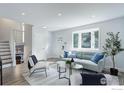 Bright and airy living room features modern decor, recessed lighting, and a large window at 1150 Atlantis Ave, Lafayette, CO 80026