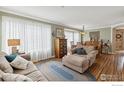 Inviting living room with hardwood floors, neutral color scheme, and an abundance of natural light at 14396 Corrine Ct, Broomfield, CO 80023