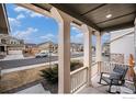 Inviting front porch view with rocking chair, showcasing the neighborhood and pleasant surroundings at 16317 Saint Paul St, Thornton, CO 80602