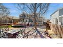 Enjoyable backyard features a patio with outdoor seating and a spacious deck for entertaining at 1875 Gordon Dr, Erie, CO 80516