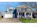 Charming two-story home with a welcoming front porch and well-maintained lawn at 1875 Gordon Dr, Erie, CO 80516