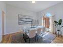 Elegant dining room with hardwood floors, modern decor, and abundant natural light from the large windows at 2425 Waneka Lake Trl, Lafayette, CO 80026
