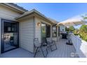 Outdoor patio area with seating, grill, umbrella, and sliding glass door access to the home at 2425 Waneka Lake Trl, Lafayette, CO 80026