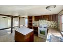 Kitchen featuring an island, oven, and ample countertop space at 339 Lilac Cir, Lochbuie, CO 80603