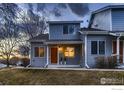 Inviting townhome showcasing light blue siding, an orange front door, and a cozy covered porch at 500 Lashley St # 58, Longmont, CO 80504