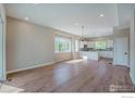 Bright, open-concept living space with hardwood floors and modern lighting at 8500 W 62Nd Ave # D, Arvada, CO 80004