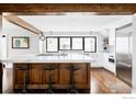 Modern kitchen features a large island with seating, stainless steel appliances, and an abundance of natural light at 920 Hawthorn Ave, Boulder, CO 80304