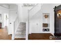 Bright stairway with built-in storage and white railings, leading to the upper level of the home at 920 Hawthorn Ave, Boulder, CO 80304
