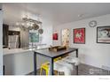 Eat-in kitchen featuring a modern table and a view of the stainless steel refrigerator at 1031 Portland Pl # 4, Boulder, CO 80304