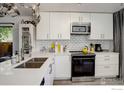 Bright kitchen with white cabinetry, stainless steel appliances, and modern countertops at 1031 Portland Pl # 4, Boulder, CO 80304