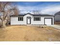 Charming single-story home with white siding, a well-manicured yard, and an attached garage at 10792 Moore St, Broomfield, CO 80021