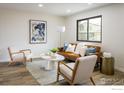 Bright living room featuring neutral paint, modern furniture and large windows with natural light at 10792 Moore St, Broomfield, CO 80021