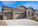 Charming home featuring a three-car garage, stone accents, neutral siding and covered porch, perfect for enjoying outdoor living at 12596 Eagle River Rd, Firestone, CO 80504