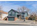 Charming two-story home with a well-maintained yard and attached garage on a sunny day at 1454 Alpine St, Longmont, CO 80504