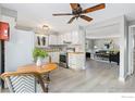 Bright kitchen featuring white cabinets, stainless steel appliances, and a cozy breakfast nook at 159 Judson St, Longmont, CO 80501