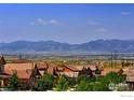 Expansive mountain views over the neighboring rooftops and mature green trees at 15955 Humboldt Peak Dr, Broomfield, CO 80023