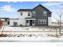 Modern two-story home with gray and white siding, a well-kept lawn, and wintery landscaping at 1784 Glacier Ave, Berthoud, CO 80513