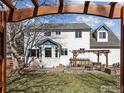 Back of house featuring a pergola-covered patio and well-maintained lawn at 2111 Pintail Dr, Longmont, CO 80504